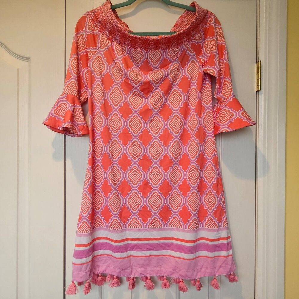Cabana Life Coral Geo Smocked Off-the-Shoulder Mini Dress featuring tassel trim.
